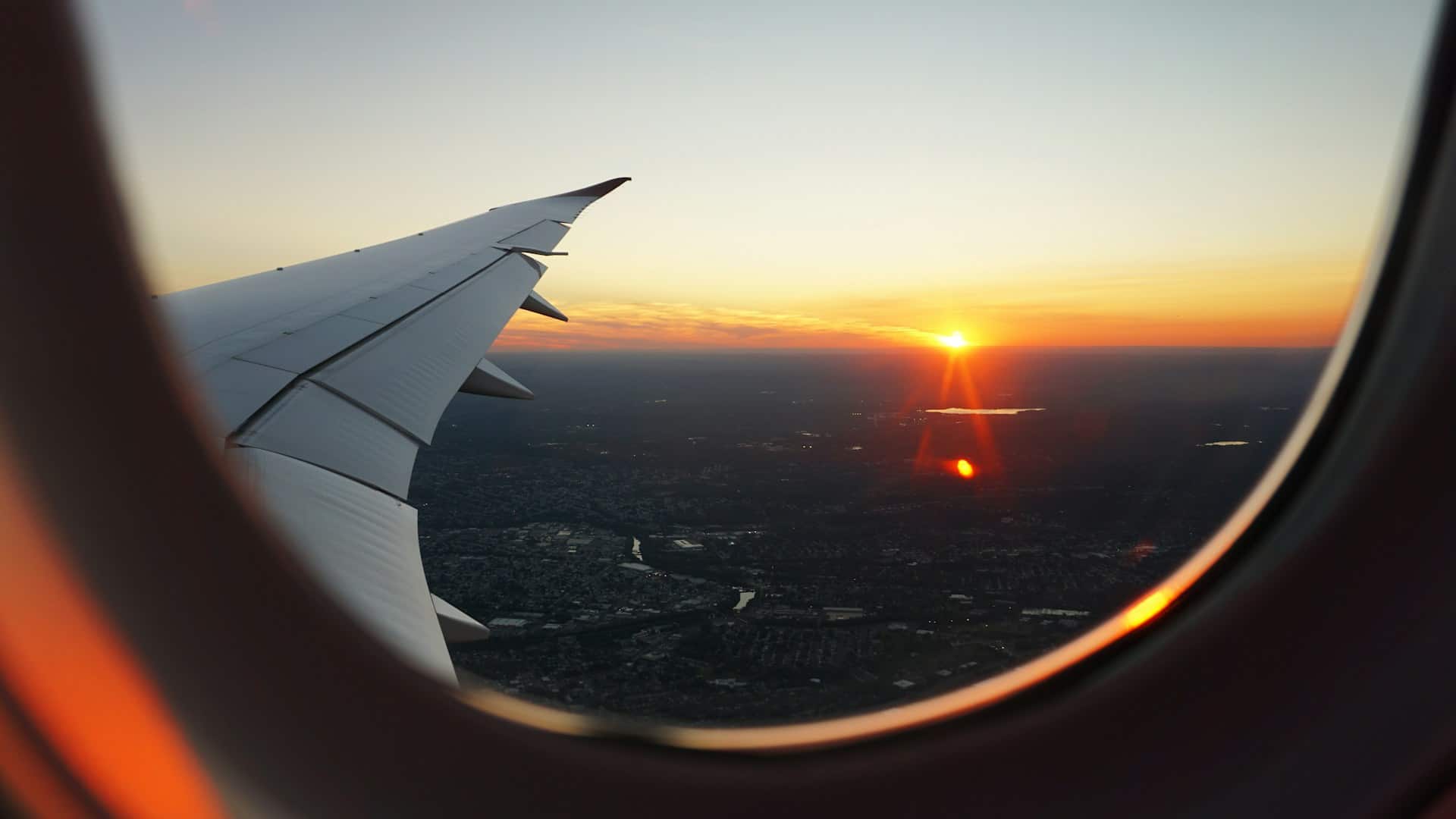 View of a sunset through an aircraft cabin window
